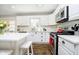 Bright kitchen with a central island, white cabinetry, modern appliances, and hardwood flooring at 9270 N Temple Ave, Indianapolis, IN 46240