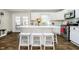 Bright kitchen featuring a large island, white cabinets, stainless steel appliances, and hardwood floors at 9270 N Temple Ave, Indianapolis, IN 46240