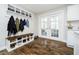 Mud room with bench seating, storage shelves, and French doors leading to an outdoor space at 9270 N Temple Ave, Indianapolis, IN 46240