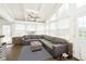 Bright sunroom with vaulted ceilings, brick accents, and comfortable seating with a large sectional couch at 9270 N Temple Ave, Indianapolis, IN 46240