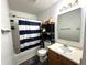 Cozy bathroom with shower-tub combination and vanity featuring wood finish and storage at 9873 Blue Ridge Way, Indianapolis, IN 46234
