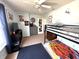 This bedroom includes a bunk bed, a TV, and walls decorated with posters at 9873 Blue Ridge Way, Indianapolis, IN 46234