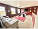Spacious bonus room features multiple windows, a ceiling fan, and comfortable seating at 9873 Blue Ridge Way, Indianapolis, IN 46234