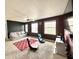 Spacious bonus room features multiple windows, a ceiling fan, and comfortable seating at 9873 Blue Ridge Way, Indianapolis, IN 46234