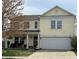 Charming two-story home featuring a light yellow exterior and a well-maintained front yard at 9873 Blue Ridge Way, Indianapolis, IN 46234