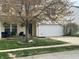 Well-manicured front yard featuring a mature tree and a freshly poured concrete driveway at 9873 Blue Ridge Way, Indianapolis, IN 46234
