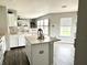 Bright kitchen with an island, white cabinets, and large windows offering backyard views at 9873 Blue Ridge Way, Indianapolis, IN 46234