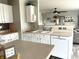 Open concept kitchen featuring white cabinets, modern appliances, and hardwood floors at 9873 Blue Ridge Way, Indianapolis, IN 46234