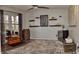 Charming living room featuring luxury vinyl plank flooring, shelving, and a decorative ceiling fan at 9873 Blue Ridge Way, Indianapolis, IN 46234