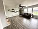 Spacious living room with hardwood floors, modern lighting, and large windows at 9873 Blue Ridge Way, Indianapolis, IN 46234