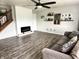 Comfortable living room with a decorative fireplace, hardwood floors, and stylish furnishings at 9873 Blue Ridge Way, Indianapolis, IN 46234