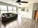 Bright living room featuring hardwood floors, a cozy sofa, and large windows at 9873 Blue Ridge Way, Indianapolis, IN 46234