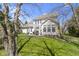 Spacious backyard featuring a covered patio, lush lawn, and mature trees at 10471 Meadow Lake Dr, Fishers, IN 46038