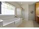 Bright bathroom with a large tub, separate shower, and built-in storage at 10471 Meadow Lake Dr, Fishers, IN 46038
