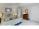 Bright bedroom features a comfortable bed, neutral walls, and wood accents at 10471 Meadow Lake Dr, Fishers, IN 46038
