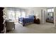 Serene bedroom with blue bedding, soft lighting, and a comfortable seating area at 10471 Meadow Lake Dr, Fishers, IN 46038