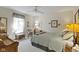 Comfortable bedroom with soft lighting, a ceiling fan, and a window seat near the curtained window at 10471 Meadow Lake Dr, Fishers, IN 46038