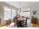 Sun-filled dining room with wood table set, decorative chandelier, and hardwood floors at 10471 Meadow Lake Dr, Fishers, IN 46038