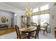 Elegant dining room featuring a chandelier, large windows, and sophisticated decor at 10471 Meadow Lake Dr, Fishers, IN 46038