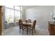 Bright dining room with an oval wood table, four chairs, and large window with curtains at 10471 Meadow Lake Dr, Fishers, IN 46038