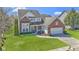 Charming two-story brick home with lush green lawn, driveway, and attached two-car garage at 10471 Meadow Lake Dr, Fishers, IN 46038
