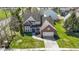 A two-story brick home with a two-car garage, well-kept lawn, and mature landscaping in a residential neighborhood at 10471 Meadow Lake Dr, Fishers, IN 46038