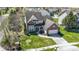 A well-maintained two-story brick home with manicured lawns, a two-car garage, and lush greenery at 10471 Meadow Lake Dr, Fishers, IN 46038