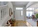 Elegant foyer with hardwood floors, staircase, and a view into the dining room at 10471 Meadow Lake Dr, Fishers, IN 46038