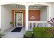 Inviting front porch with brick accents, white columns, and a cozy seating area at 10471 Meadow Lake Dr, Fishers, IN 46038