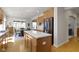 Charming kitchen featuring stainless fridge, island with white countertop, and hardwood floors at 10471 Meadow Lake Dr, Fishers, IN 46038