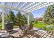 Backyard patio area with pergola, brick flooring, dining table and grill at 10471 Meadow Lake Dr, Fishers, IN 46038