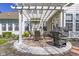 Outdoor patio area with pergola, brick flooring, dining table and grill at 10471 Meadow Lake Dr, Fishers, IN 46038