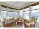 Bright sunroom with ceiling fan, lots of windows, and comfortable furniture at 10471 Meadow Lake Dr, Fishers, IN 46038