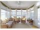 Sunroom with large windows offering natural light, ceiling fan, and comfortable seating at 10471 Meadow Lake Dr, Fishers, IN 46038