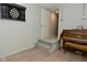 Basement area with a piano, steps to a door, and dart board, adding an artistic element at 1053 Reserve Way, Indianapolis, IN 46220
