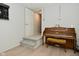 Basement area with a piano, steps to a door, and dart board, adding an artistic element at 1053 Reserve Way, Indianapolis, IN 46220