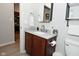 Bathroom with a modern vanity, wooden cabinets, a mirror, and a toilet at 1053 Reserve Way, Indianapolis, IN 46220