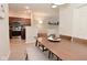 Inviting dining area with a wooden table, bench seating and view to kitchen featuring stainless steel appliances at 1053 Reserve Way, Indianapolis, IN 46220
