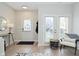 Bright entryway featuring light hardwood floors, a white door, and glass patio doors at 1053 Reserve Way, Indianapolis, IN 46220