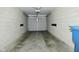 A one car garage with cement walls and grey door, great for parking and storage at 1053 Reserve Way, Indianapolis, IN 46220