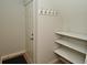 Well-organized hallway with coat hooks, a door and built-in shelving for storage at 1053 Reserve Way, Indianapolis, IN 46220