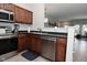 Kitchen featuring stainless steel dishwasher, sink, wooden cabinets and modern appliances at 1053 Reserve Way, Indianapolis, IN 46220