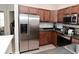 Kitchen with stainless steel refrigerator, wood cabinets, and modern appliances at 1053 Reserve Way, Indianapolis, IN 46220