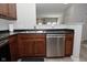 Close-up of kitchen featuring stainless steel dishwasher, sink, and wood cabinets at 1053 Reserve Way, Indianapolis, IN 46220