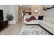 Open-concept living room with hardwood floors, white couch, and view of the kitchen at 1053 Reserve Way, Indianapolis, IN 46220