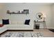 Comfortable living room with a white sofa, hardwood floors, and a decorative shelf at 1053 Reserve Way, Indianapolis, IN 46220