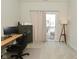 Bright office space featuring desk, comfortable chair and sliding glass doors to outside at 1053 Reserve Way, Indianapolis, IN 46220