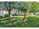 Green lawn and mature trees create a serene backdrop to the outdoor space that features a patio and seating at 10955 Chapel Woods N Blvd, Noblesville, IN 46060