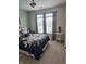 Cozy bedroom with natural light, complemented by a floral bedding set and a view of the outdoors at 10955 Chapel Woods N Blvd, Noblesville, IN 46060