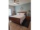 A comfortable bedroom with a ceiling fan, lamps, and a large bed at 10955 Chapel Woods N Blvd, Noblesville, IN 46060
